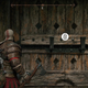 Kratos stands in front of a door in God of War Ragnarok on PS5, except this door has a bigger button.